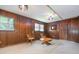 Finished basement room featuring wood paneling, unique lighting, and sitting area at 5152 Suggs St, Powder Springs, GA 30127