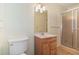 Bathroom with a vanity, a toilet, and a shower with glass doors at 5152 Suggs St, Powder Springs, GA 30127