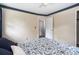 Bedroom showcasing floral bedding, neutral walls, and a view of an open doorway at 5152 Suggs St, Powder Springs, GA 30127