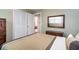 Bedroom with neutral tones, mirrored dresser, and a closet at 5152 Suggs St, Powder Springs, GA 30127