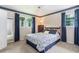 Cozy bedroom featuring neutral walls, a ceiling fan, and two windows with blue curtains at 5152 Suggs St, Powder Springs, GA 30127