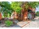 Charming brick building with inviting outdoor seating and lush greenery along the sidewalk at 5152 Suggs St, Powder Springs, GA 30127