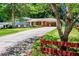 Charming home featuring a long driveway and inviting curb appeal with mature trees and red shutters at 5152 Suggs St, Powder Springs, GA 30127
