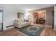 Inviting living room featuring hardwood floors, a comfortable sofa, and seamless access to the dining area at 5152 Suggs St, Powder Springs, GA 30127