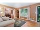 Comfortable living room with hardwood floors, natural light, and a view into the adjacent dining area at 5152 Suggs St, Powder Springs, GA 30127