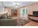 Comfortable living room with hardwood floors, a ceiling fan, and access to the outside at 5152 Suggs St, Powder Springs, GA 30127