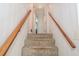 Carpeted staircase with wood railing leading to the upper level at 5152 Suggs St, Powder Springs, GA 30127