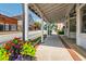 Scenic street view highlighting the charming covered walkway with vibrant floral arrangements at 5152 Suggs St, Powder Springs, GA 30127