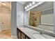 Bathroom showcasing double sinks, granite countertop, large vanity mirror and updated lighting at 708 Edgeley Ln, Lawrenceville, GA 30044
