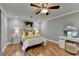 Well-lit bedroom with wood floors, ceiling fan, and stylish décor at 708 Edgeley Ln, Lawrenceville, GA 30044