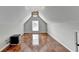 Spacious upstairs bonus room with hardwood flooring and a large window for natural light at 708 Edgeley Ln, Lawrenceville, GA 30044