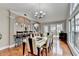Open-concept dining room with hardwood floors, a table, a bar, and seamless flow to other living spaces at 708 Edgeley Ln, Lawrenceville, GA 30044