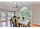 The dining room features hardwood floors, a table, and windows offering backyard views at 708 Edgeley Ln, Lawrenceville, GA 30044