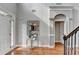 Elegant foyer featuring hardwood floors, decorative mirror and an open archway at 708 Edgeley Ln, Lawrenceville, GA 30044