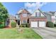 Charming brick two-story home featuring a well-manicured lawn and a two-car garage at 708 Edgeley Ln, Lawrenceville, GA 30044