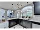The kitchen boasts an island, stainless appliances, and modern lighting, seamlessly connecting to the living spaces at 708 Edgeley Ln, Lawrenceville, GA 30044