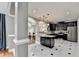 Modern kitchen with dark cabinets, stainless steel appliances, and tile floors at 708 Edgeley Ln, Lawrenceville, GA 30044