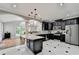 The kitchen features dark cabinetry, stainless steel appliances, granite countertops, and a dining area at 708 Edgeley Ln, Lawrenceville, GA 30044