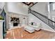 Bright and open living room featuring hardwood floors, staircase, and natural light at 708 Edgeley Ln, Lawrenceville, GA 30044