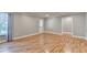 A well lit living room with wood flooring and a white door leading outside at 708 Edgeley Ln, Lawrenceville, GA 30044