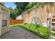 Cozy backyard featuring a small patio, wooden fence, play set, and lush green ground cover at 1955 Shawn Wayne Se Cir, Atlanta, GA 30316