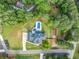 Aerial view of a home with a pool, surrounded by lush greenery and well-maintained landscaping at 200 Whispering Pines Dr, Woodstock, GA 30188