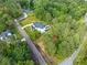 Aerial view of the property showcasing the house, a private pool, and lush green landscaping at 200 Whispering Pines Dr, Woodstock, GA 30188