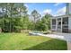 Inviting backyard with a modern pool, patio area, and screened porch, perfect for entertaining at 200 Whispering Pines Dr, Woodstock, GA 30188