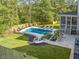 Relaxing backyard featuring a pool with lounge chairs, a patio, and a screened-in porch at 200 Whispering Pines Dr, Woodstock, GA 30188
