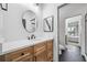 Bright bathroom featuring wooden cabinets, white counters, and modern fixtures at 200 Whispering Pines Dr, Woodstock, GA 30188