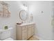 Well-lit bathroom features a modern vanity, round mirror, and combined tub and shower at 200 Whispering Pines Dr, Woodstock, GA 30188