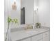 Bright bathroom featuring marble counters, gold hardware and fixtures, and natural light at 200 Whispering Pines Dr, Woodstock, GA 30188