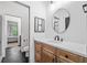 Well-lit bathroom with wooden cabinets, white countertops, and hexagon tile floors at 200 Whispering Pines Dr, Woodstock, GA 30188