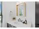 Bathroom features designer mirror and fixtures over a modern vanity with a marble countertop at 200 Whispering Pines Dr, Woodstock, GA 30188