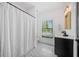 Bathroom featuring black and white tile floor, shower with striped curtain and modern vanity at 200 Whispering Pines Dr, Woodstock, GA 30188