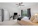 Bright bedroom with a ceiling fan, a window and ensuite bathroom featuring designer tile at 200 Whispering Pines Dr, Woodstock, GA 30188
