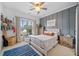 Cozy bedroom featuring paneled accent wall, natural light, and stylish décor at 200 Whispering Pines Dr, Woodstock, GA 30188