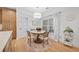 Cozy breakfast nook with a round table, four chairs, and natural light from a window at 200 Whispering Pines Dr, Woodstock, GA 30188