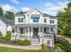 Charming two-story home with a welcoming front porch and professionally landscaped yard at 200 Whispering Pines Dr, Woodstock, GA 30188