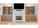 Elegant fireplace with built-in shelving on either side and a mounted television at 200 Whispering Pines Dr, Woodstock, GA 30188
