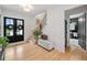 Bright foyer with hardwood floors, staircase, and a view to the home office at 200 Whispering Pines Dr, Woodstock, GA 30188