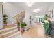 Inviting foyer with hardwood floors, staircase, and a view to the living room at 200 Whispering Pines Dr, Woodstock, GA 30188