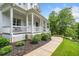 Charming home featuring a wide porch, manicured landscaping, and a welcoming walkway at 200 Whispering Pines Dr, Woodstock, GA 30188