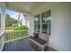Relaxing front porch with a charming bench, offering views of the well-manicured front yard at 200 Whispering Pines Dr, Woodstock, GA 30188