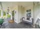 Spacious front porch with a porch swing and wreaths on the double front doors for added curb appeal at 200 Whispering Pines Dr, Woodstock, GA 30188