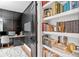 Well-appointed home office featuring custom storage and adjacent bookshelves at 200 Whispering Pines Dr, Woodstock, GA 30188