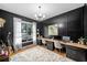 Stylish home office with custom built-ins, hardwood floors, and a large window at 200 Whispering Pines Dr, Woodstock, GA 30188