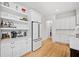 Modern kitchen featuring white cabinets, hardwood floors, and a beverage center at 200 Whispering Pines Dr, Woodstock, GA 30188