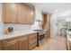 Modern kitchen with stainless steel appliances, quartz countertops, and ample cabinet space at 200 Whispering Pines Dr, Woodstock, GA 30188