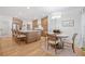 Modern kitchen with an island, breakfast bar, stainless steel appliances, and an adjacent dining area at 200 Whispering Pines Dr, Woodstock, GA 30188
